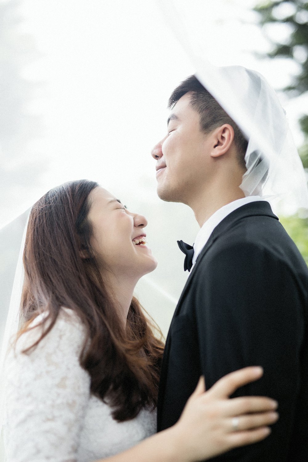 Bride laughing with her groom