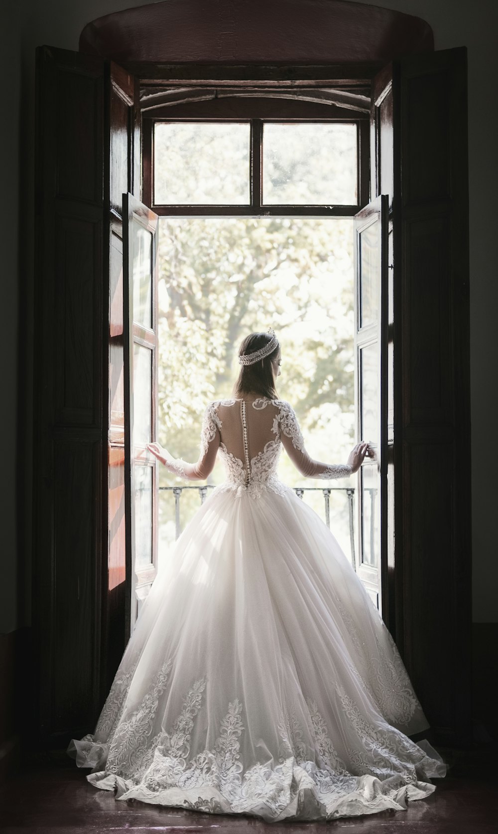 Bride in a full ball gown standing in a doorway