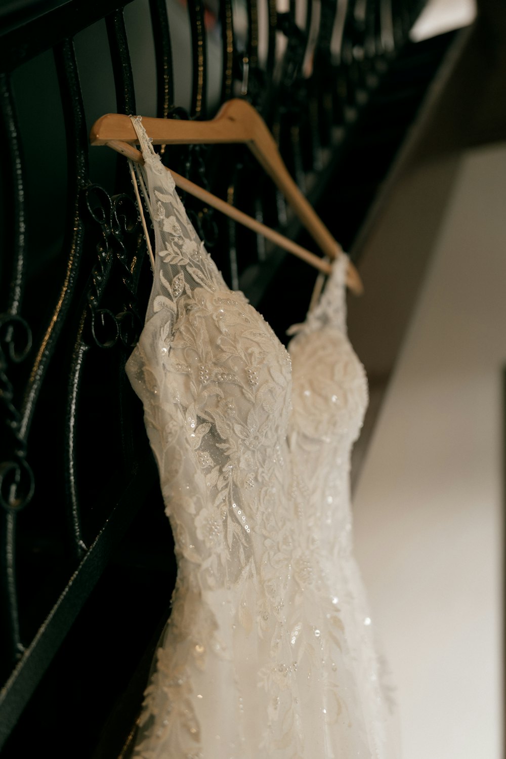 Beaded gown on a wooden hanger